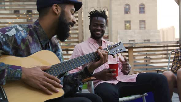 Young adult friends hanging out on a rooftop