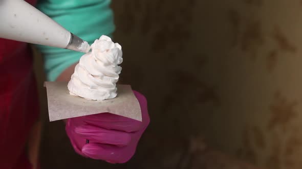 Woman Makes Marshmallow Cones. Using A Pastry Bag. Close Up Shot..