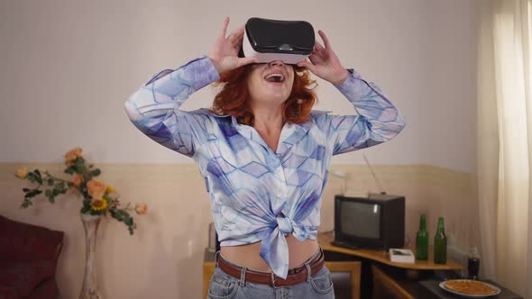 Excited Caucasian Retro Woman in Vintage VR Headset Standing Indoors Admiring Augmented Reality