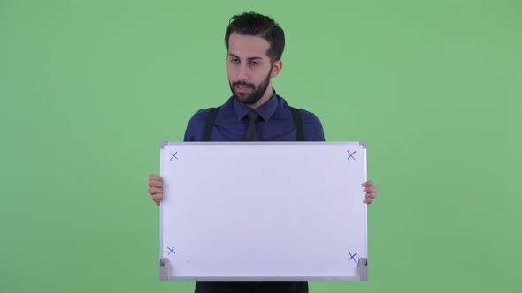 Stressed Young Bearded Persian Businessman Holding White Board