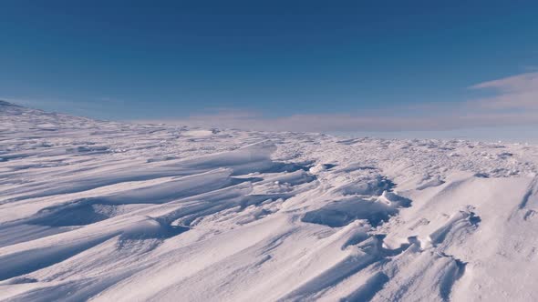 Dolly Shot over Frozen Snowy Structure in Sunny Winter Mountains Pattern Texture Background