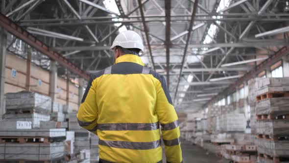 Worker Male Warehouse Worker Engineer Man in A Helmet Working on The Construction Site