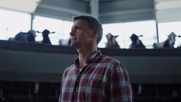 Dairy Farm Manager Controlling Milking Carousel in Modern Ranch Closeup