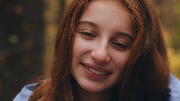 Portrait of Young Girl in Autumn Park