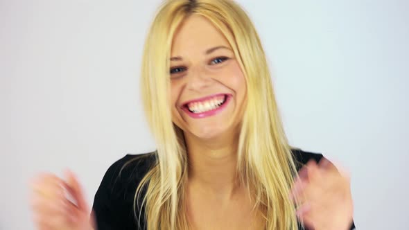 A Young Attractive Woman Waves Excitedly at the Camera - Face Closeup - White Screen Studio