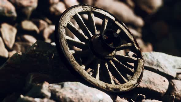 Old Wooden Wheel on Rocks