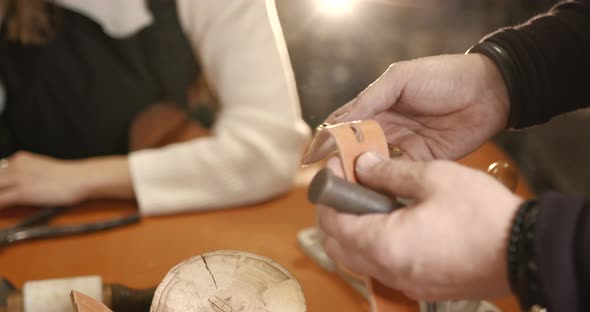 Leather Craftsman Working with a Belt in a Workshop