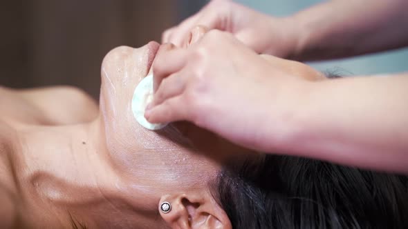 Removing Cream From Face of Wellness Spa Customer