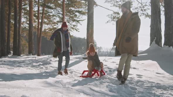 Slowmo of Family of Three Enjoying Winter Day