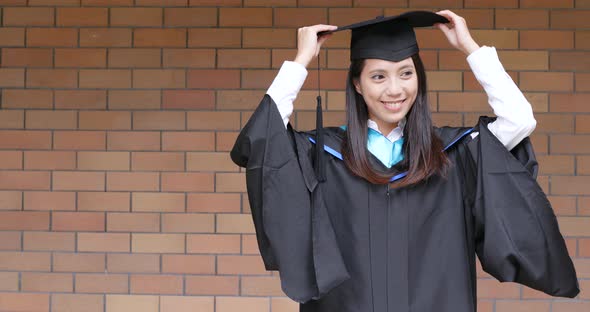 Woman with graduation gown in university gown