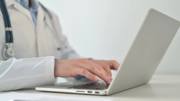 Doctor Typing on Laptop