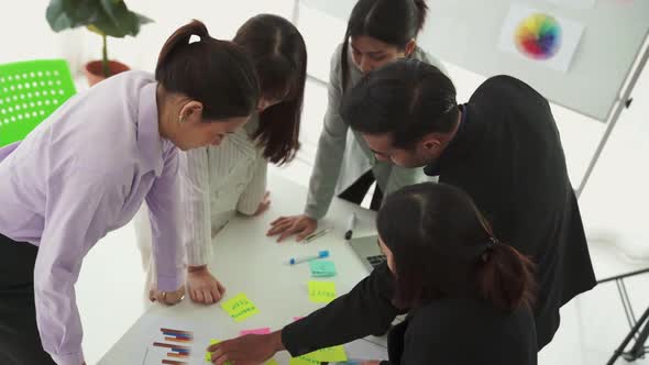 Business People Proficiently Discuss Work Project on Meeting Table