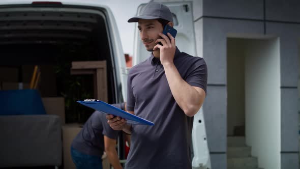 Tracking video of delivery man calling a customer. Shot with RED helium camera in 8K.