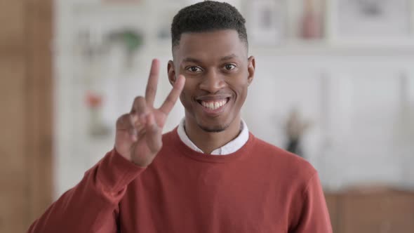 Portrait of African Businessman showing Victory Sign with Finger