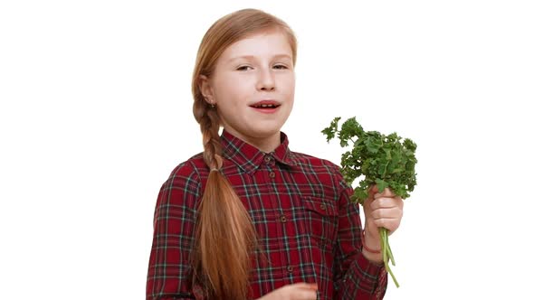 Elementaryschool Aged Caucasian Girl with Plait of Hair Holding Bunch of Greenery and Smelling It