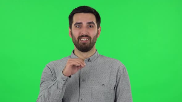 Portrait of Brunette Guy Is Screaming Calling Someone. Green Screen