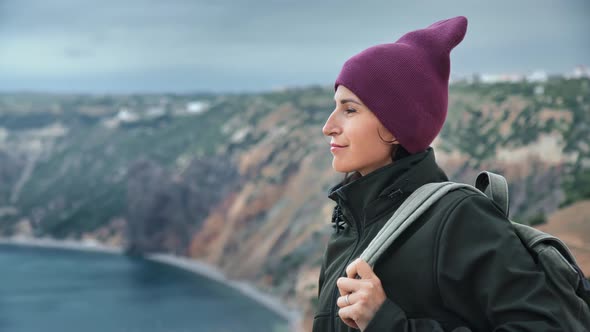 Happy Woman Tourist with Backpack Admiring Nature Sea Scenery From Top of High Mountain