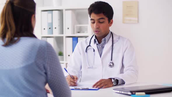 Indian Doctor with Papers and Patient at Hospital 50