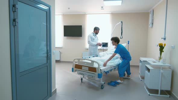 Hospital room with old woman and doctor and nurse near