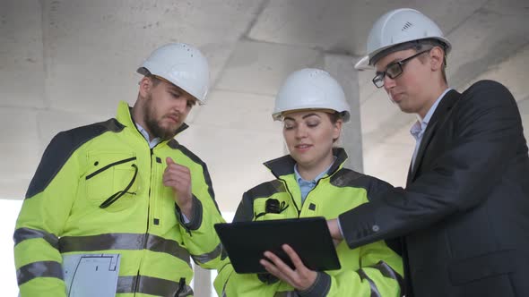 Architect or engineer working, browsing building project indoor of construction