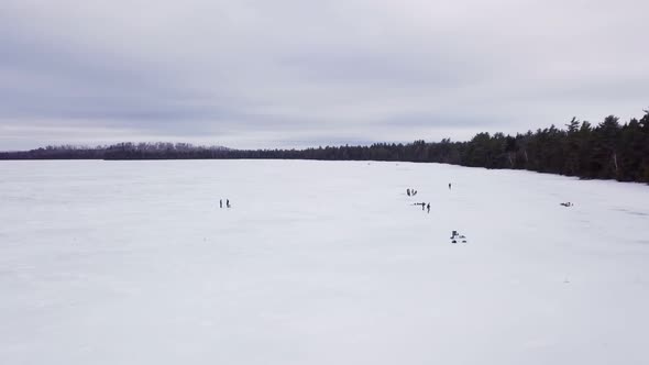 Get an aerial view of Ice Fishing on Fitzgerald Pond, Maine. Here we pass by many small groups.