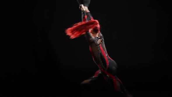Redhead Slim Beautiful Woman Spinning Fast Hanging on Air Hoop in Stage Costume