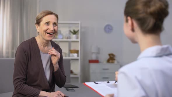 Mature Woman Sincerely Rejoicing Hearing Good News About Her Health From Doctor