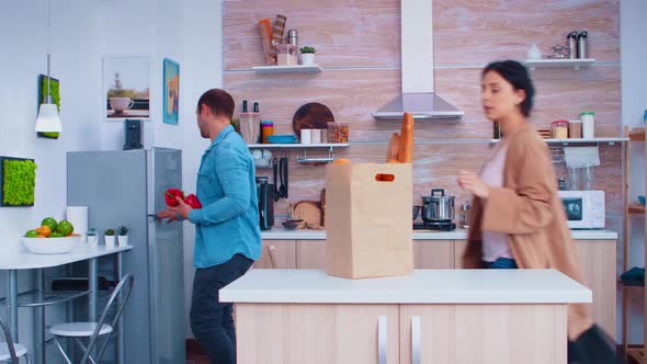 Husband and Wife Taking Out Vegetables