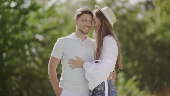 Beautiful Couple In Love Embracing In Nature. Portrait Of Woman And Handsome Man