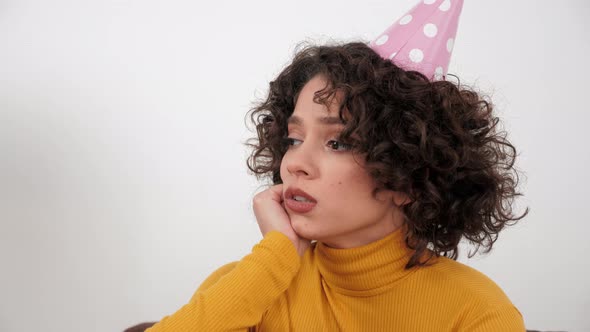 Upset Woman in Party Hat Looking Away Celebration Holiday Birthday Alone at Home