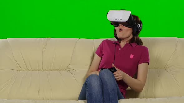 Woman in Virtual Reality Glasses on the Couch. Green Screen. Close Up