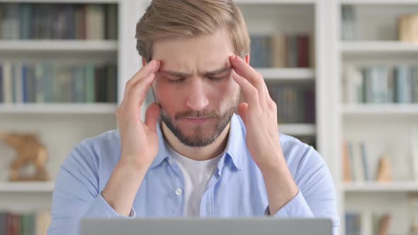 Portrait of Man Having Headache While Using Laptop
