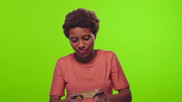 Chroma Key Footage of a Dark-skinned Curly Woman Plays Games Online