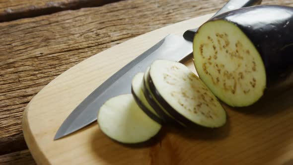 Sliced eggplant with knife on chopping board 4k