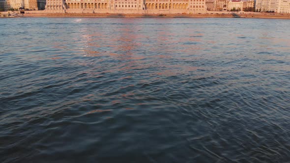 Aerial view to Hungarian Parliament from the Danube river at sunset, Budapest, Hungary