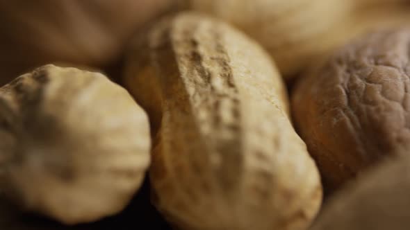 Cinematic, rotating shot of a variety of nuts on a white surface - NUTS MIXED 045