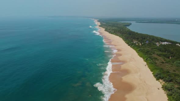 Sea coast, view from the height. Sandy beach with blue sea.