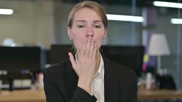 Portrait of Attractive Young Businesswoman Giving Flying Kiss