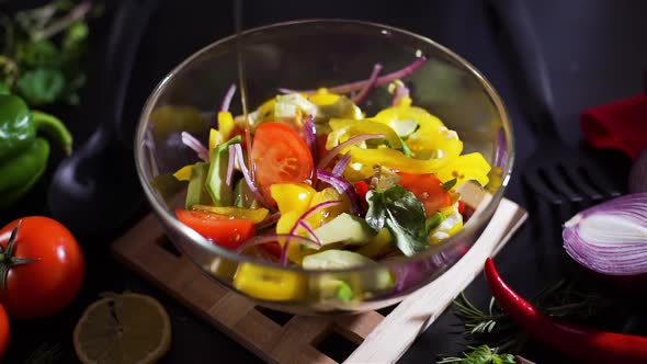 Pouring Olive Oil in a Bowl with Vegetable Salad