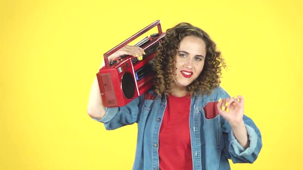 Curly Girl Dancing with a Red Old Cassette Tape on Her Shoulder, Slow Motion