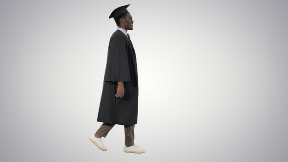 Cheerful african graduate student dancing with diploma