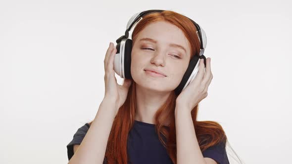 Young Beautiful Caucasian Foxy Teenage Girl Listening Music Through Headphones Dancing Smiling on