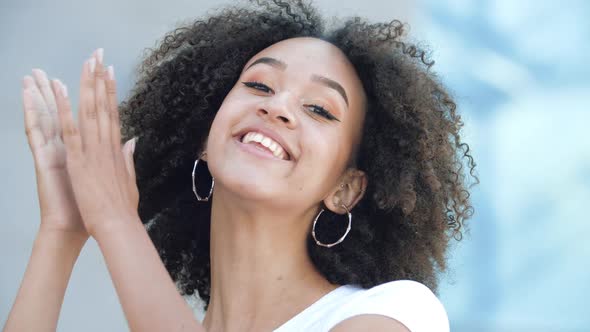 Beautiful African American Girl Claps Her Hands, Smiles Toothy and Says Wow. Young Woman Is