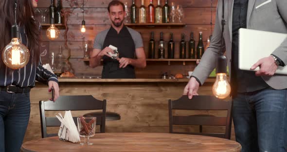 Young Female and Male Business Partners Meet in a Coffee Shop for a Fast Meeting