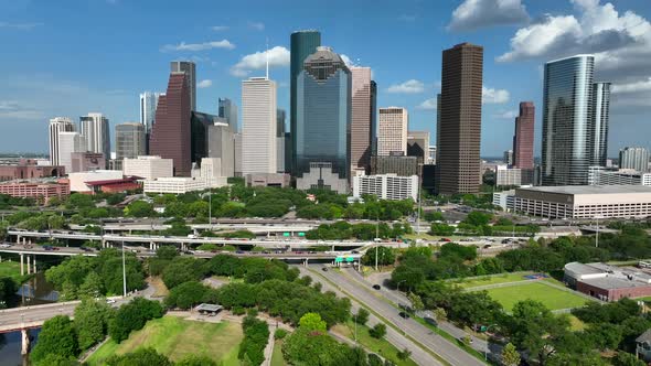 Buffalo Bayou river water with Downtown Houston Texas skyline on beautiful summer day. Aerial pullba