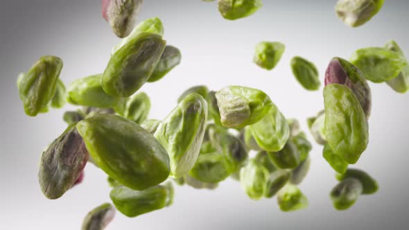 Flying of Peeled Pistachios in Dark Grey Background