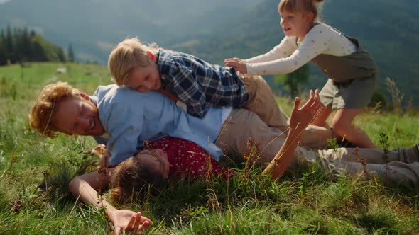 Family Piled Each Other Lying Green Grass Hill Close Up