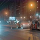 Three Road Rollers are Laying Asphalt Against the Backdrop of the City at Night - VideoHive Item for Sale