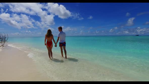 Romantic couple in love on paradise bay beach journey by clear water and white sandy background of t