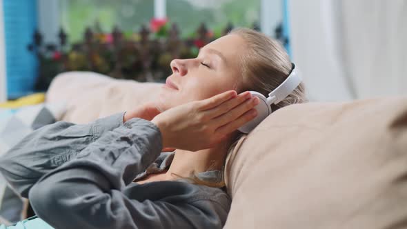 Beautiful Lady Resting on Couch Listening To Relaxing Music